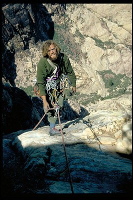 Joe Herbst, topping out on the first ascent of Rainbow Wall